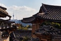 Hanok traditional houses: Korean roofs, wooden facades. Old buildings. Bukchon Hanok Village neighborhood. N tower at the Royalty Free Stock Photo