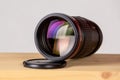 Canon EF 200mm f/2.8L II USM professional lens stands on a table Royalty Free Stock Photo