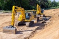 Komatsu excavator and other construction vehicles stands on a construction site