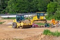 Yellow construction vehicles stands on a construction site Royalty Free Stock Photo