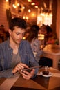 Hansdsome millennial texting on his tablet Royalty Free Stock Photo