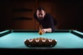 Hansome man playing billiards alone Royalty Free Stock Photo