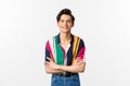 Hansome smiling gay man looking happy, standing over white background in summer outfit