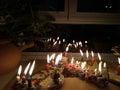 Hanukka candeles lit on a window shelf