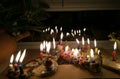 Hanukka candeles lit on a window shelf