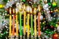 Hanukkah background with menorah and burning candles on sparkle background with defocused lights Royalty Free Stock Photo
