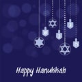 Hanukkah blue background with hanging star of David and dreidel