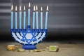 Hanukkah candles lit for the holiday celebration surrounded by d