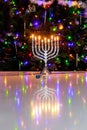 Hanukkah celebrates with menorah burning with nine candles.