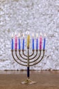 During Hanukkah celebration, candlelight lights up Hanukkah Menorah symbolizing Jewish religion holiday