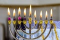 During Hanukkah celebration, candlelight lights up Hanukkah Menorah symbolizing Jewish religion holiday