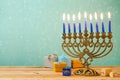 Hanukkah celebration with menorah on wooden table over bokeh background Royalty Free Stock Photo