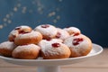 Hanukkah donuts with jelly and powdered sugar on stand against blurred festive lights, closeup Royalty Free Stock Photo