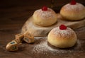 Hanukkah donutsand traditional spinning dreidel on a wooden board. Close up