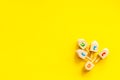 Hanukkah dreidels on yellow table. Jewish holideys concept. Top view. space for text Royalty Free Stock Photo