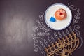 Hanukkah holiday background with menorah and sufganiyot over chalkboard. View from above