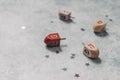 Hanukkah holiday concept. Closeup of wooden dreidel toys, golden and silver confetti stars decoration on grunge concrete