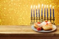 Hanukkah holiday sufganiyot with menorah on wooden table Royalty Free Stock Photo