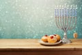 Hanukkah holiday sufganiyot and menorah on wooden table Royalty Free Stock Photo