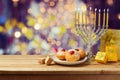 Hanukkah holiday sufganiyot and menorah on wooden table Royalty Free Stock Photo