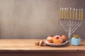 Hanukkah holiday sufganiyot and menorah on wooden table Royalty Free Stock Photo