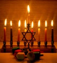 Hanukkah is a Jewish holiday. Burning Chanukah candlestick with candles. Chanukiah Menorah. dreidel, savivon