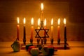 Hanukkah is a Jewish holiday. Burning Chanukah candlestick with candles. Chanukiah Menorah. dreidel, savivon