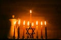 Hanukkah is a Jewish holiday. Burning Chanukah candlestick with candles. jug of oil. Chanukiah Menorah