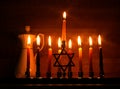 Hanukkah is a Jewish holiday. Burning Chanukah candlestick with candles. jug of oil. Chanukiah Menorah