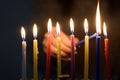 Jewish Woman lighting Hanukkah Candles in a menorah.