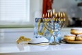 During Hanukkah Jewish religion holiday celebration, a Menorah candlelights