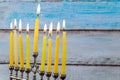 Hanukkah menorah with candles and silver dreidel. Royalty Free Stock Photo