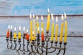 Hanukkah menorah with candles and silver dreidel. Royalty Free Stock Photo