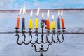 Hanukkah menorah with candles and silver dreidel. Royalty Free Stock Photo