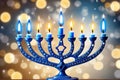 Hanukkah menorah with candles on table against blurry light, religious Jewish