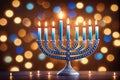 Hanukkah menorah with candles on table against blurry light, religious Jewish