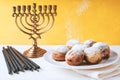 Hanukkah menorah and sufganiot on the table horizontal