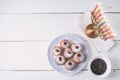 Hanukkah menorah and sufganiot on the white wooden table top view