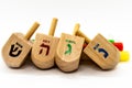 Hanukkah traditional dreidels and candles on the white background