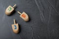 Hanukkah traditional dreidels on grey table. Space for text Royalty Free Stock Photo