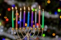 Hanukkiah Menorah with burned candles on blurred bokeh in the Jewish holiday symbol for Hanukkah