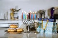 Hanukkiah Menorah candle is lit during a traditional celebration of Jewish holiday
