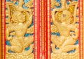 The hanuman golden carved on red door in buddhism temple