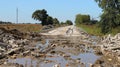 Haphazard piles of rubble line the sides of a nowimpassable road evidence of the intense flooding that swept through the