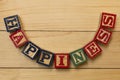 Hapiness wood cube words on wooden table cool