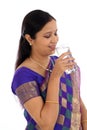 Happ young traditional woman drinking glass of water