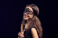 Happe woman in mask holding glass with champagne Royalty Free Stock Photo