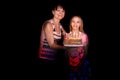 The happiest family.Mom gives her daughter a birthday cake with burning candles
