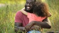 Happiest father on Earth embracing cherished daughter in tight and tender hug