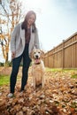 Happiest are those with pets in their lives. an attractive young woman having fun with her dog on an autumn day in a Royalty Free Stock Photo